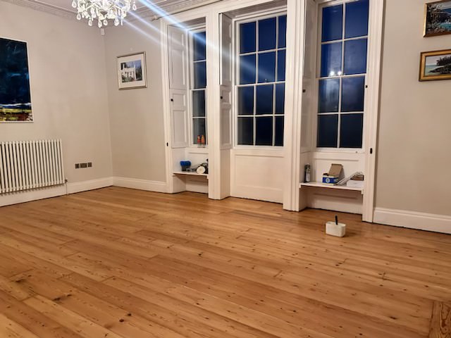 A beautifully restored wooden floor after being covered in tar.